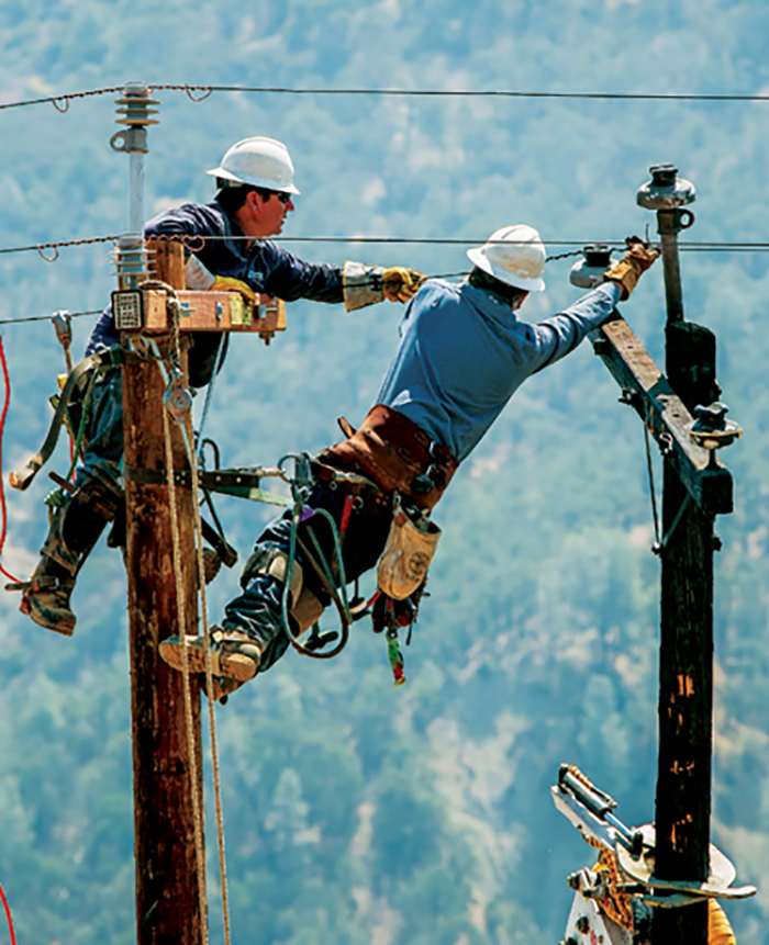 IBEW 1245 members from PG&amp;E replace poles in steep terrain after being destroyed by the "Rocky Fire" in Clearlake, Calif., on August 6th, 2015.